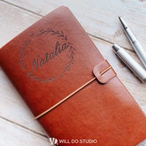 Dark leather notebook a5 with engraved text or logo