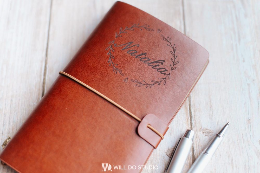 Dark leather notebook a5 with engraved text or logo