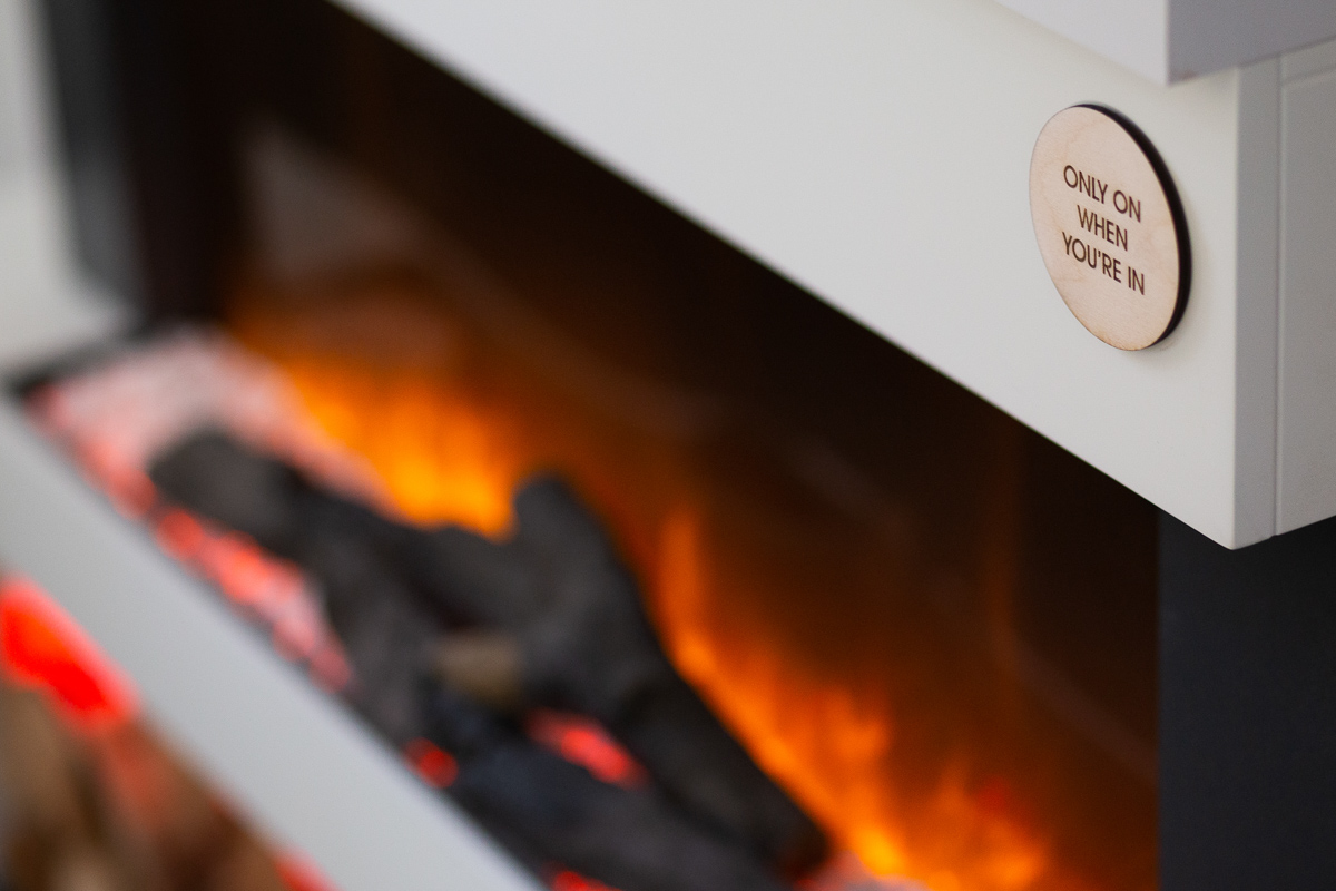 Engraved wooden instruction disc on an electric fireplace
