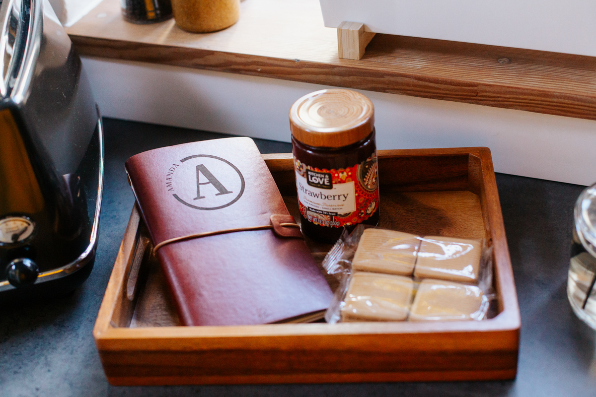 Personalised welcome tray with a leather journal and treats for a guest