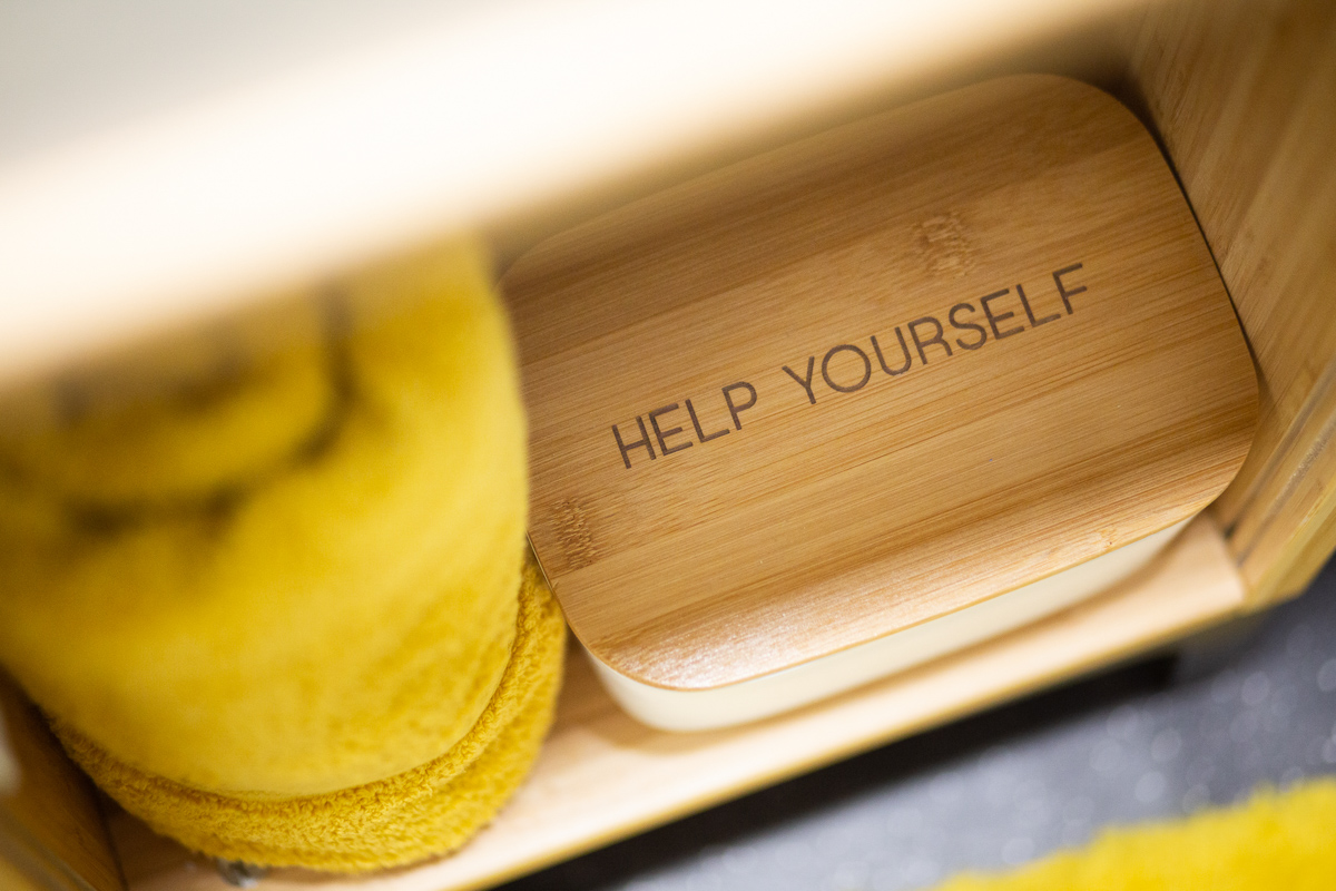 Engraved bamboo amenity box labelled for a bathroom