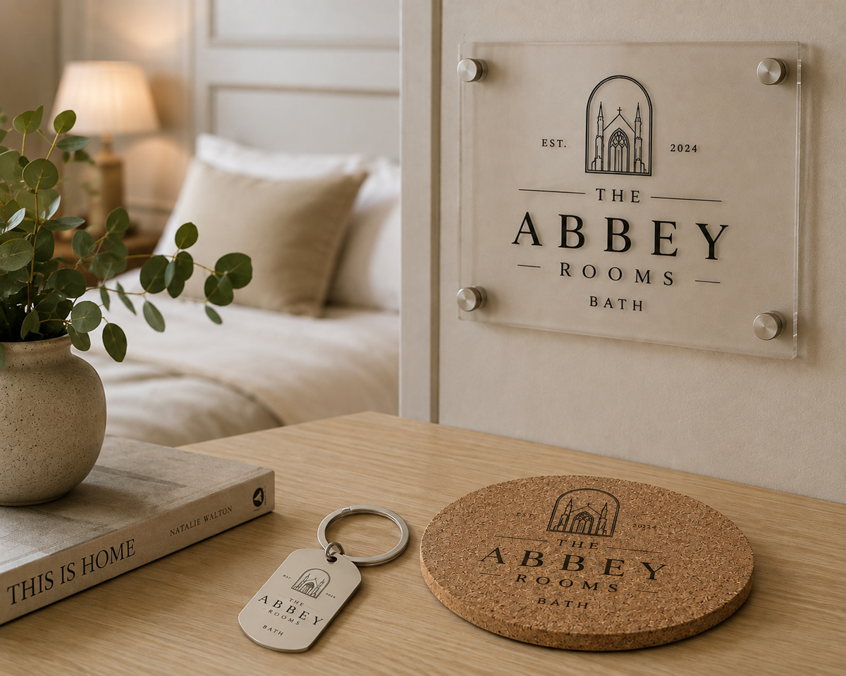Personalised marble and wood serving board and coasters engraved with a hotel crest